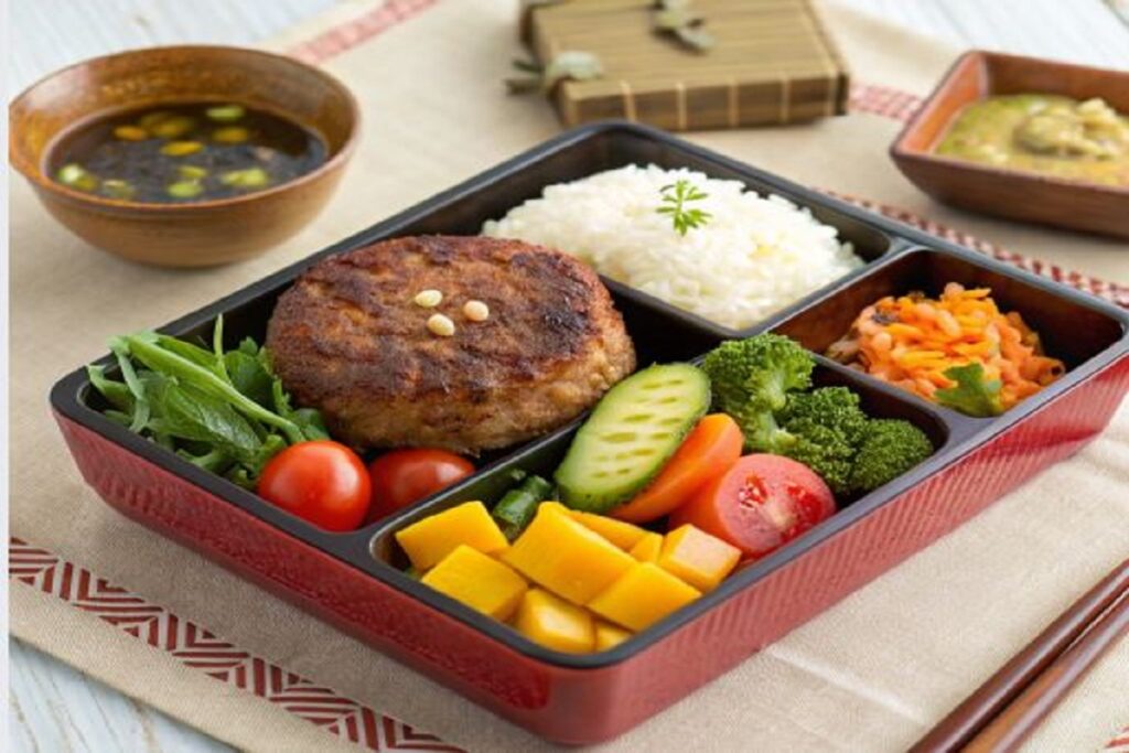 Bento box with minced beef patty and vegetables. Minced Beef Japanese Recipe 