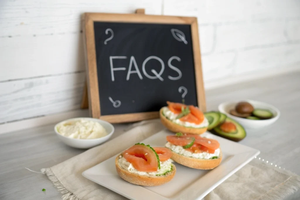 Section FAQ with Japanese bagels garnished with various toppings on an elegant plate, accompanied by a chalkboard label.