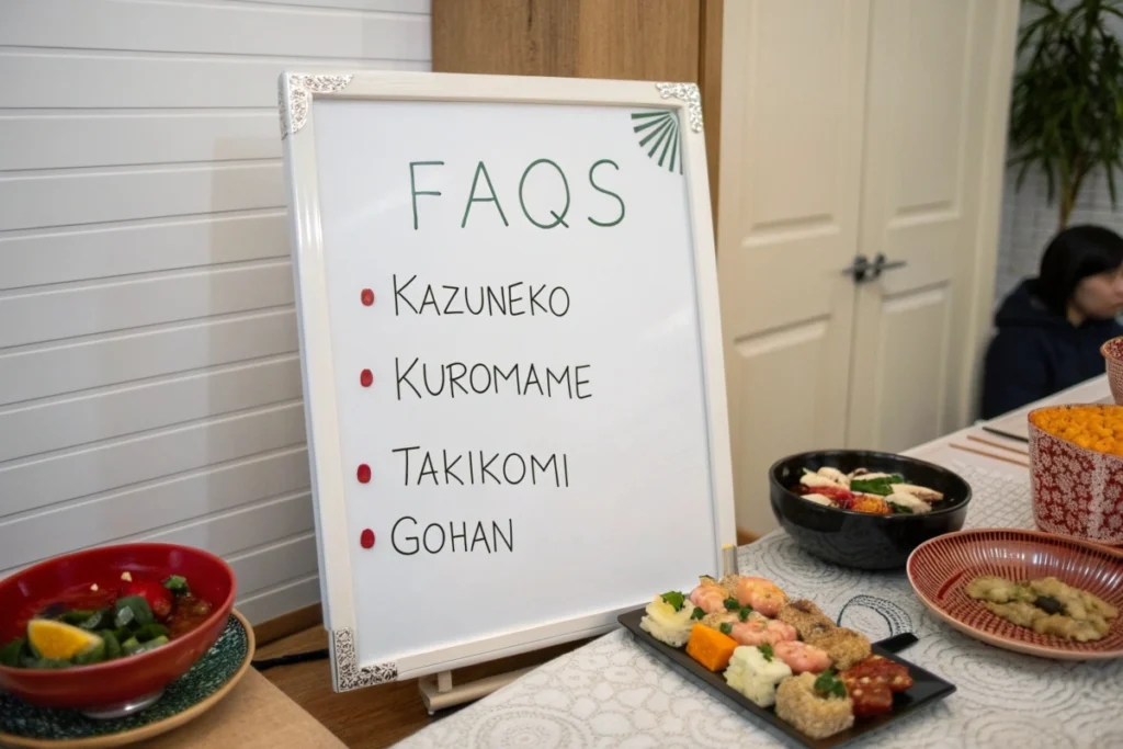 A kitchen whiteboard listing frequently asked questions about Japanese New Year foods, beside a table set with assorted osechi dishes.